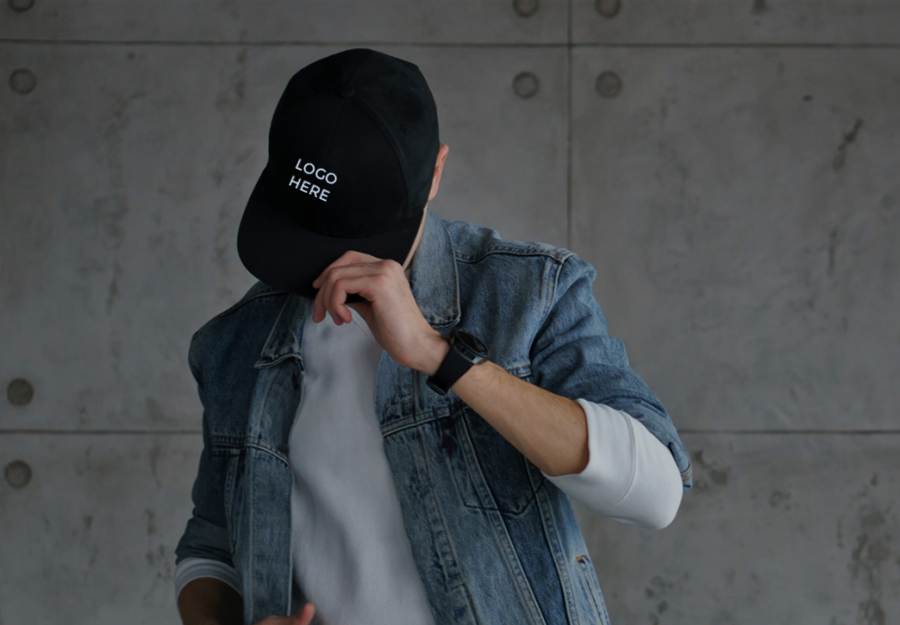 A guy wearing a custom logo hat.
